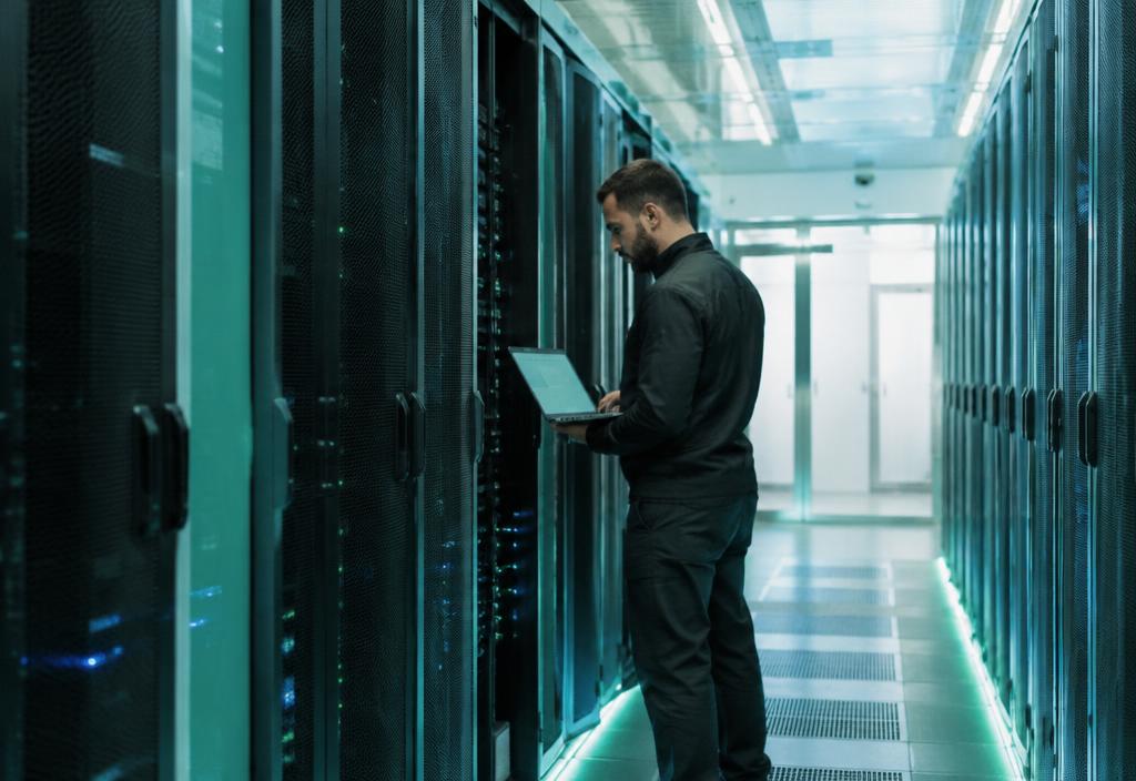 Technician checking a server rack in a data center